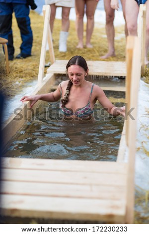 Moscow, RUSSIA - JANUARY 19: Swimming orthodox in the ice-hole, celebration of Epiphany (Holy Baptism) in the Orthodox tradition, January 19, 2014 in Moscow, Russia.