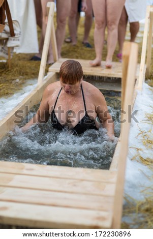 Moscow, RUSSIA - JANUARY 19: Swimming orthodox in the ice-hole, celebration of Epiphany (Holy Baptism) in the Orthodox tradition, January 19, 2014 in Moscow, Russia.