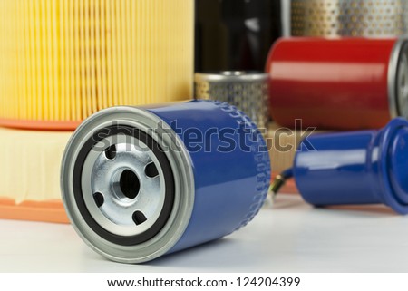 Auto oil filter on a various filter background
