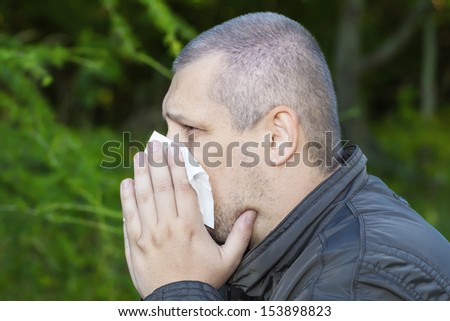Man with a runny nose and napkin