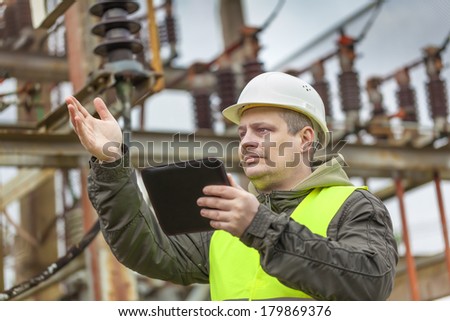 Electrical Engineer gesturing in the electric substation