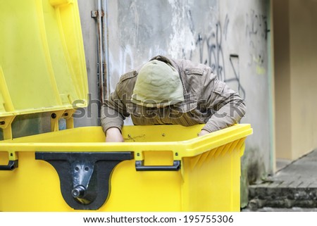 Homeless near garbage container