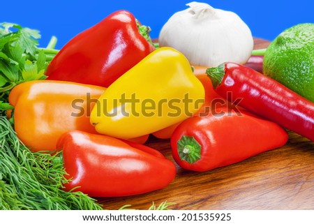 Peppers, garlic and lemon  and herbs on the table