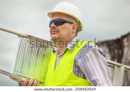 Worker with an aluminum ladder