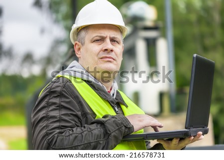 Engineer with PC at outdoor