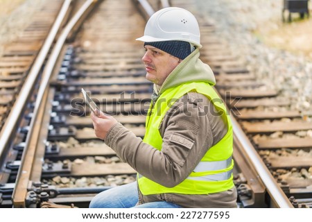 Railway engineer on rails with tablet PC