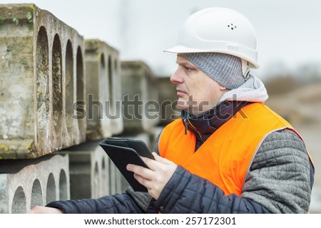 Civil engineer with tablet PC near the construction panels