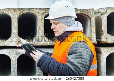 Civil engineer with tablet PC checking construction panels