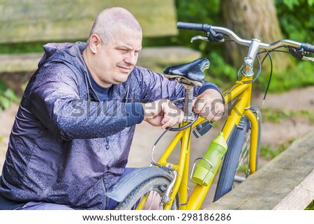 Man fixing bicycle seat