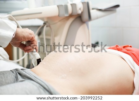Pregnant woman has her ultra sound check up. Close up concept.