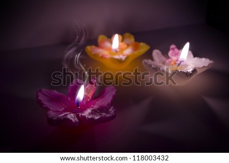 Three flower shape candles with magic smoke