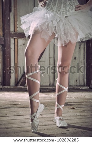 Beauty legs of ballerina standing in ballet shoes