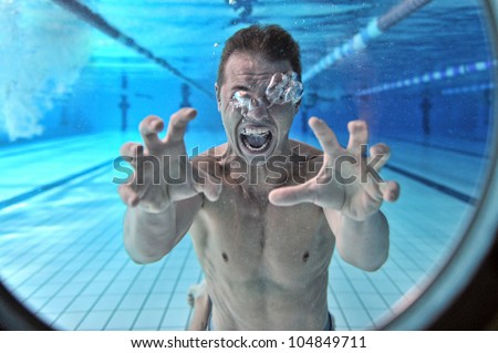 Drowning man underwater diver