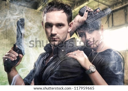 An attractive young couple with guns