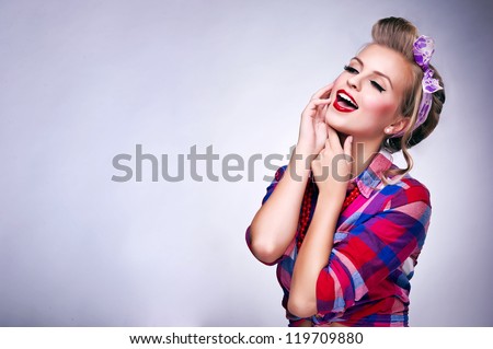 Beautiful young woman with pin-up make-up and hairstyle posing