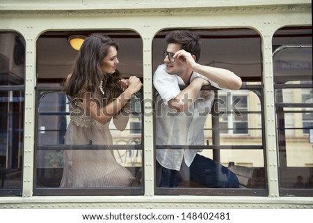 Couple with heads out the train window. Love