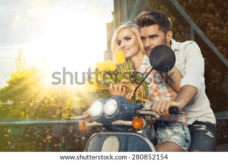 Happy free freedom couple driving scooter on summer date
