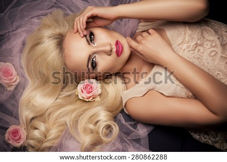 Charming blonde girl with a flowers.  Woman with beautiful face.