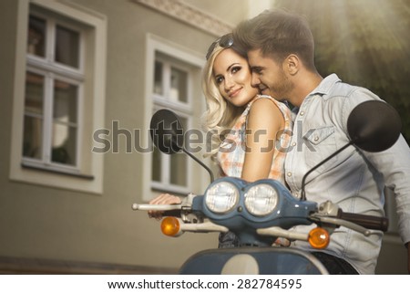 Happy free freedom couple driving scooter on summer date