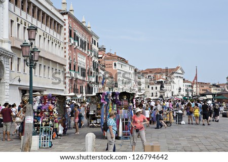VENICE - AUGUST 14: Tourists in San Marco coast on August 14, 2012 in Venice, Italy.  San Marco coast is the most important international landmark of Venice.