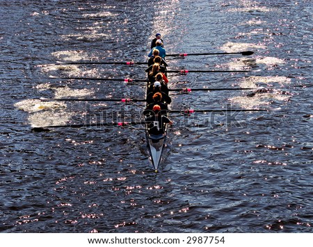 Young women athletes rowing boat