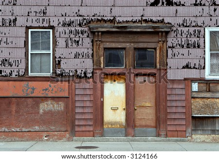 Rusty, peeling front side of rundown house in the city