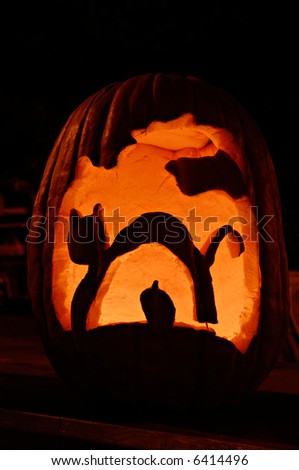 Cat and mouse carved on jack-o-lantern