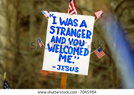 Political sign with with religious tone at a pro-immigration rally in USA