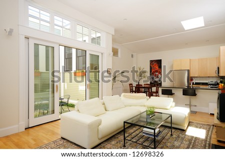 Open plan living room, dining room, kitchen and atrium in modern townhouse