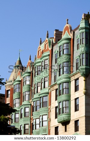 Front exterior of Boston Mansion with elegant verdigris patina on bay windows