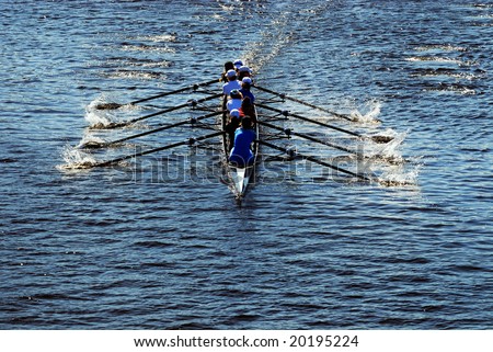 Young women athletes rowing boat