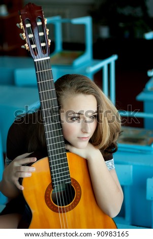 Girl with a guitar in the class