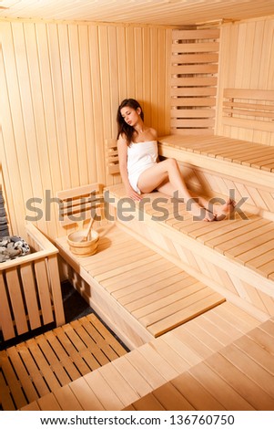 Woman Relaxing In Sauna.