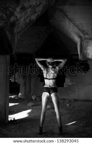 Black And White Photo Of Woman In Lingerie - Industrial Background.