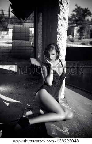 Black And White Photo Of Woman In Lingerie- Industrial Background.