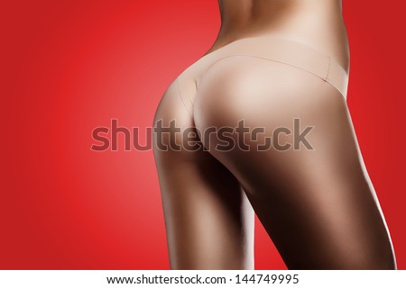 Horizontal Photo Of A Perfect Body On Black Background. Special Care And Attention For The Skin Retouching. Red Background.