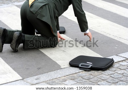 Businessman falling in the street