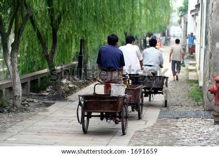 Chinese workers group on bicycle in the street