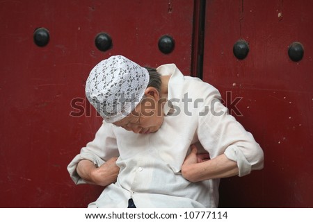 Elderly chinese woman sleeping in the street