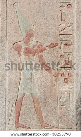 Antique egyptian carved wall with pharaoh and hieroglyphs in Luxor, Egypt