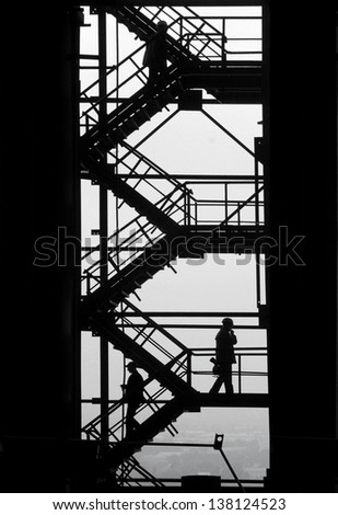 People is moving up and down the stairs of the industrial project. The metallurgical production dominate the town.