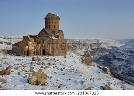 Ruins of famous  Saint Gregory (Tigran Honents) church is surrounded with winter landscape. Ani is a ruined old Armenian city situated in the Turkish province of Kars, near the border with Armenia.
