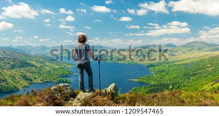 Hiking woman on top of the Mountain in Ben A'an Hill, Highlands, Scotland, Panoramic Shot - Panorama Of Landscape View From Ben A'an Hill, Highlands, Scotland