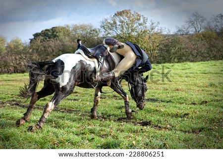 Horse rider falling off horse
