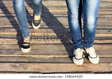 Close-up of female feet in sneakers running outdoors