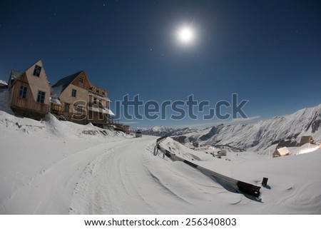 Hotels in winter snowy mountains at night. Georgia. Ski resort Gudauri. Caucasus Mountains.