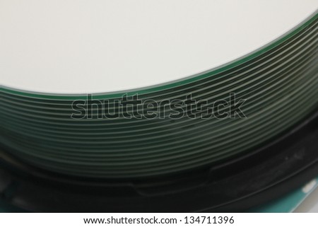 macro of stack of cd/dvds on spindle