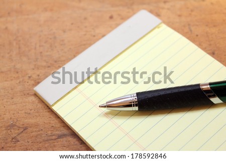 Close up of legal pad note book with pen
