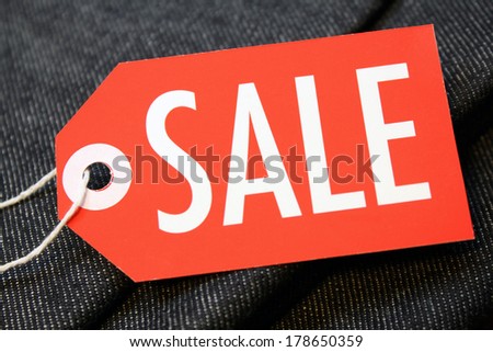 Sale tag with string on denim cotton material