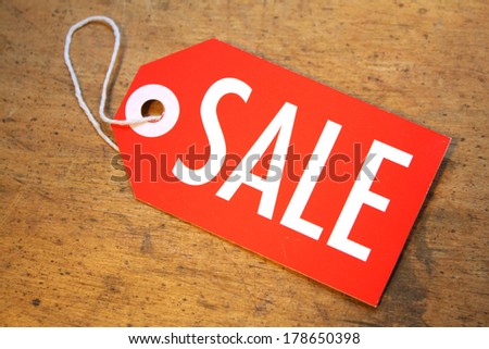 Sale tag with string on rustic wood background